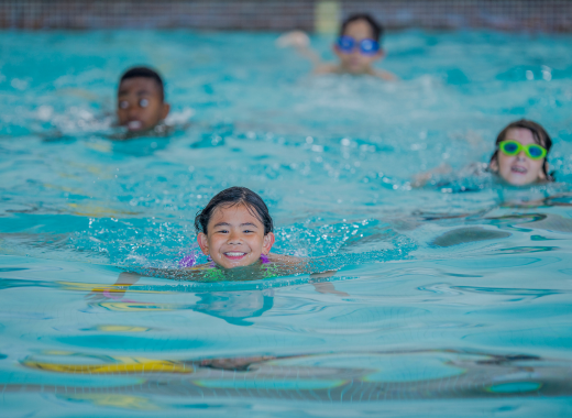 Smiling children in an indoor pool